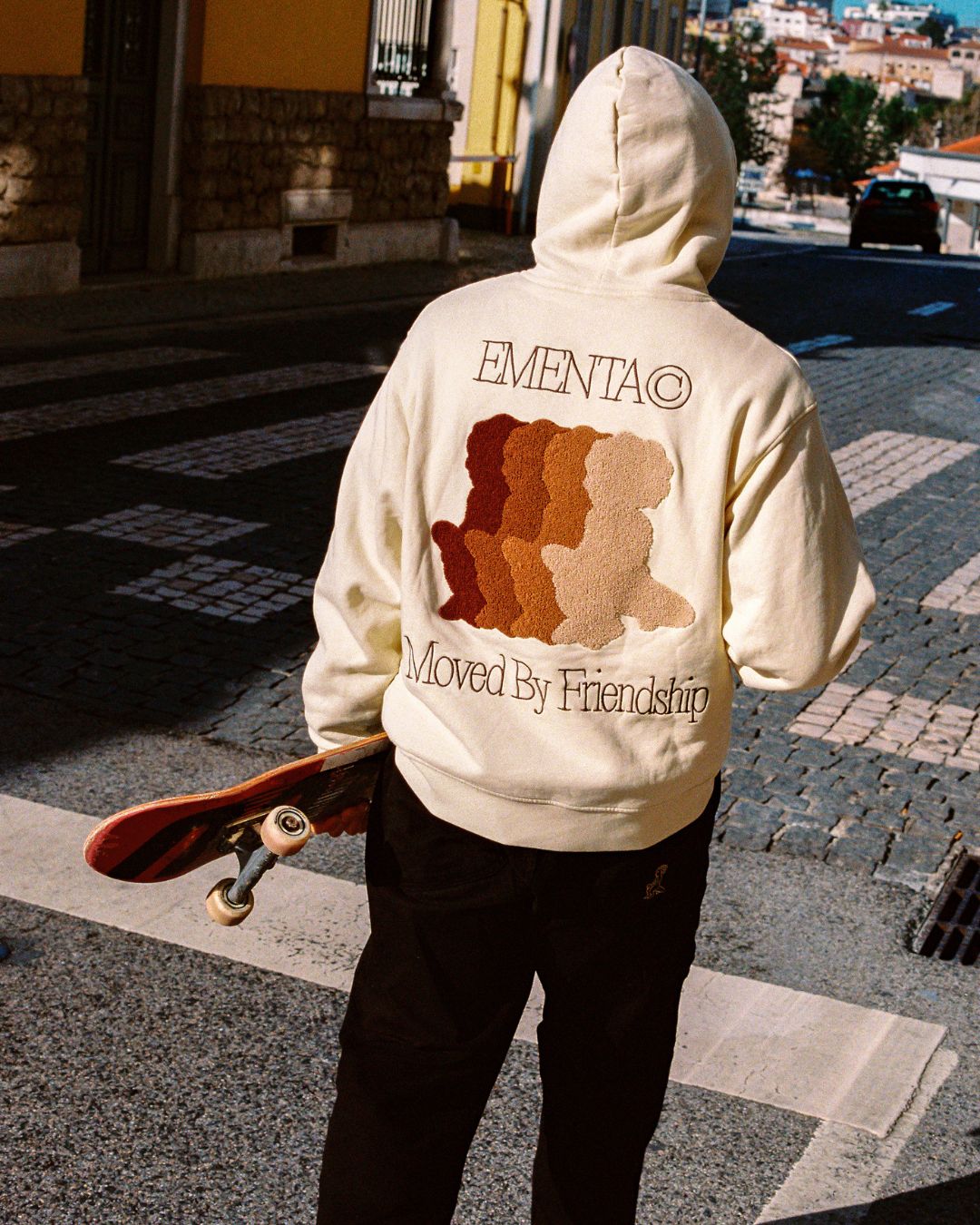 The Friendship Hoodie in off-white features the motto "Moved By Friendship" embroidered on the front in a classic handwritten style. On the back, the Ikon logo appears with a dragged effect, adding a distinctive detail.

Made from heavyweight 100% cotton, the hoodie is durable and warm, with a brushed fleece interior for extra comfort. Ribbed cuffs and hem provide structure, and the kangaroo pocket adds functionality.