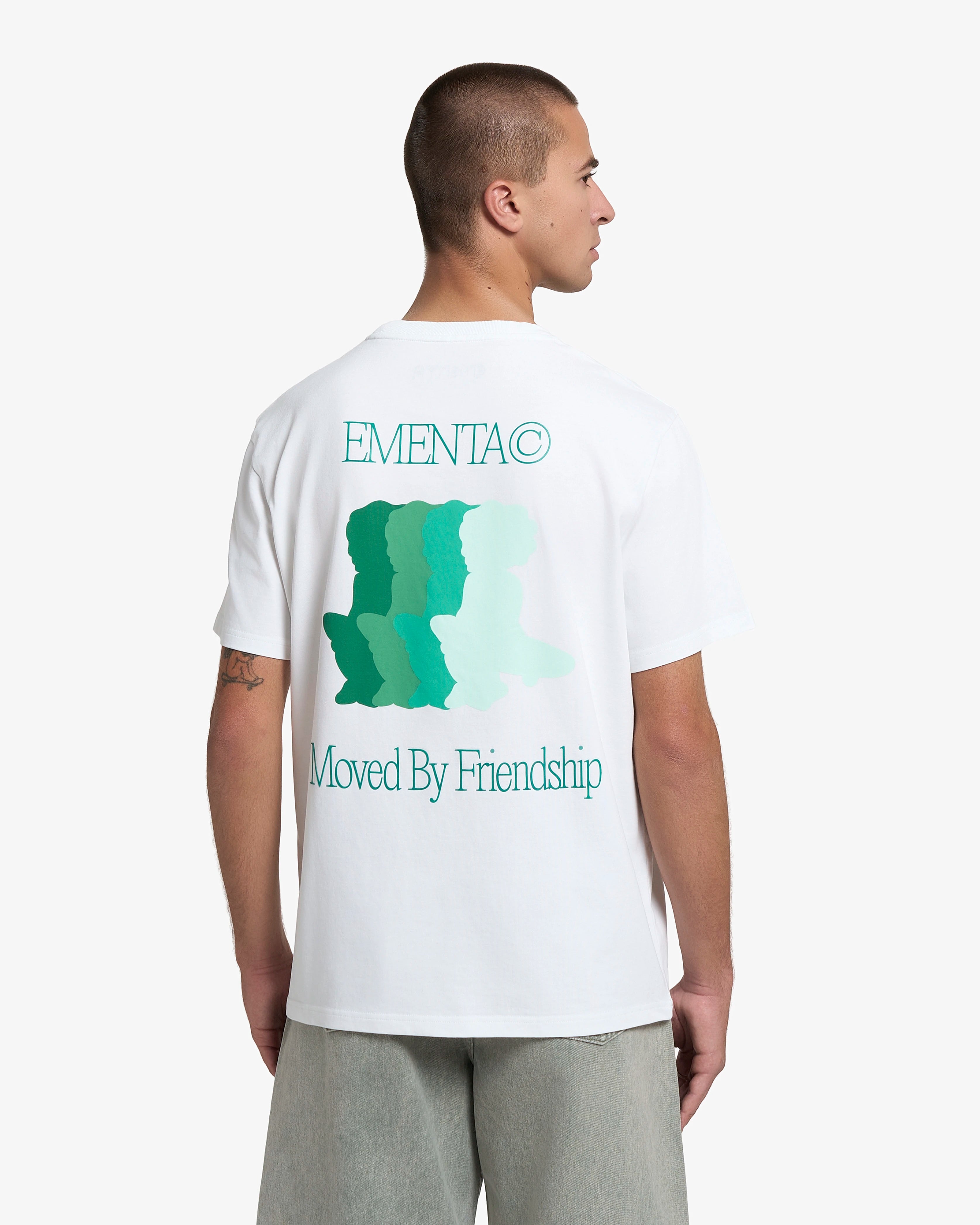 100% Cotton (220gsm)
Heavyweight cotton fabric with soft hand-feel
Boxy, relaxed fit with dropped shoulders
Ribbed crewneck collar
Screen-printed graphic on front and back
Artwork celebrates friendship and unity
"EMENTA© Moved By Friendship" motto on front and back
Double-stitched hems for durability
Made in Portugal