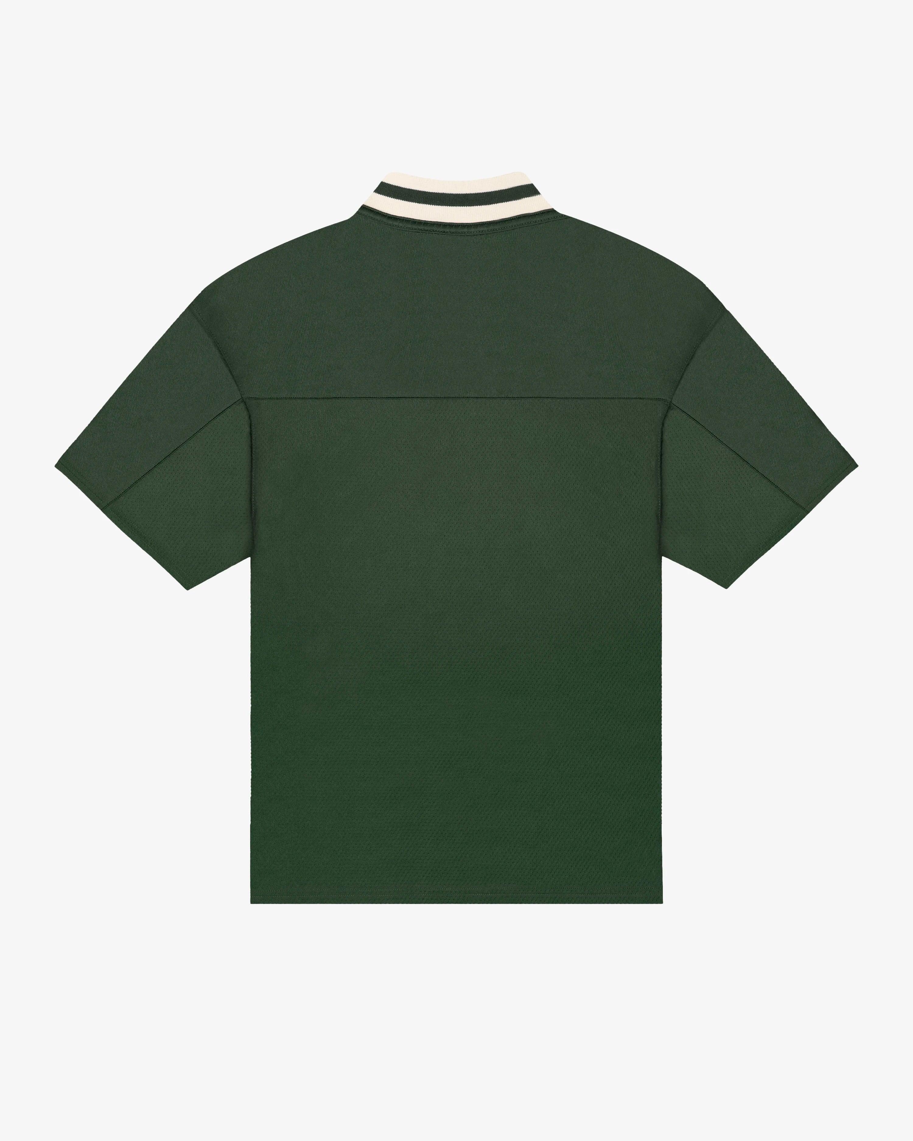 Breathable mesh fabric on the lower half, cotton-poly blend on the upper half
Oversized fit
Green color with off-white accents
Large 'EMENTA' embroidery on the chest, small branded detail embroidered on the bottom right
V-neck collar with double green stripes
Oversized sleeves for a relaxed silhouette
Part of a kit – matching shorts available online
Machine washable
