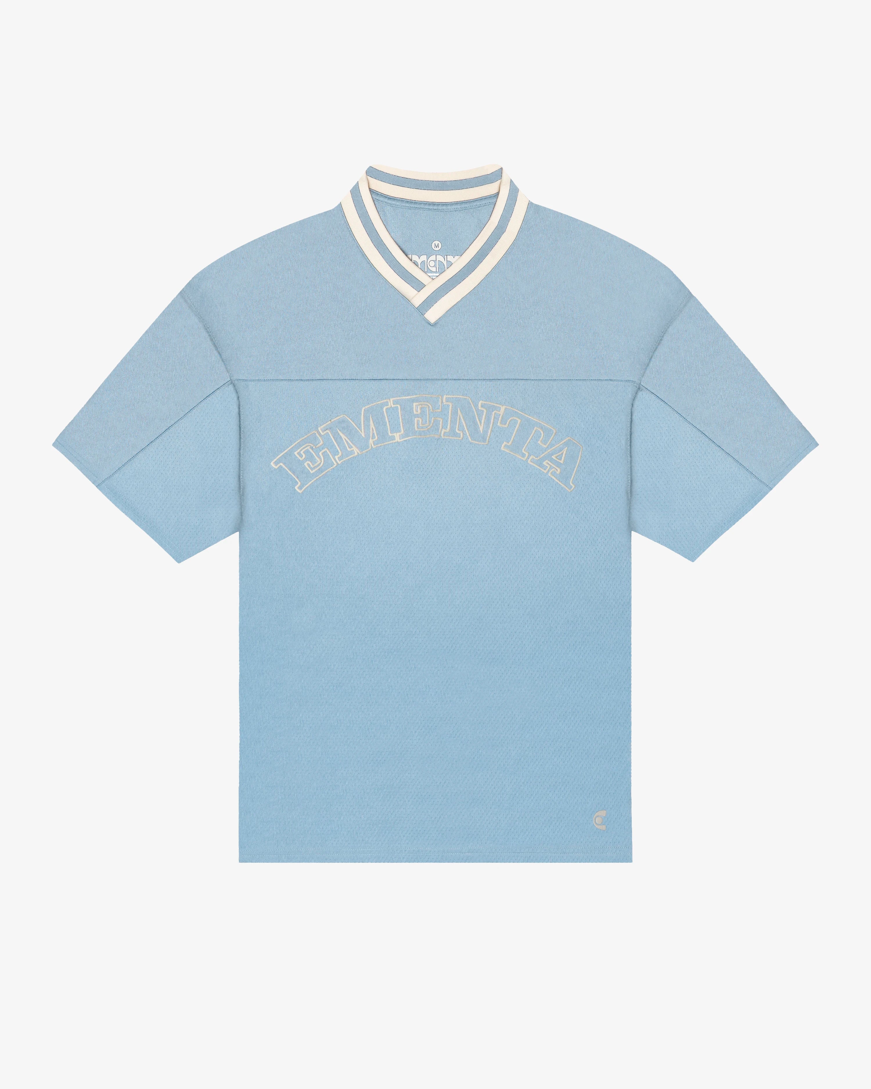Breathable mesh fabric on the lower half, cotton-poly blend on the upper half
Oversized fit
Sky blue color with off-white accents
Large 'EMENTA' embroidery on the chest, small branded detail embroidered on the bottom right
V-neck collar with double green stripes
Oversized sleeves for a relaxed silhouette
Part of a kit – matching shorts available online
Machine washable