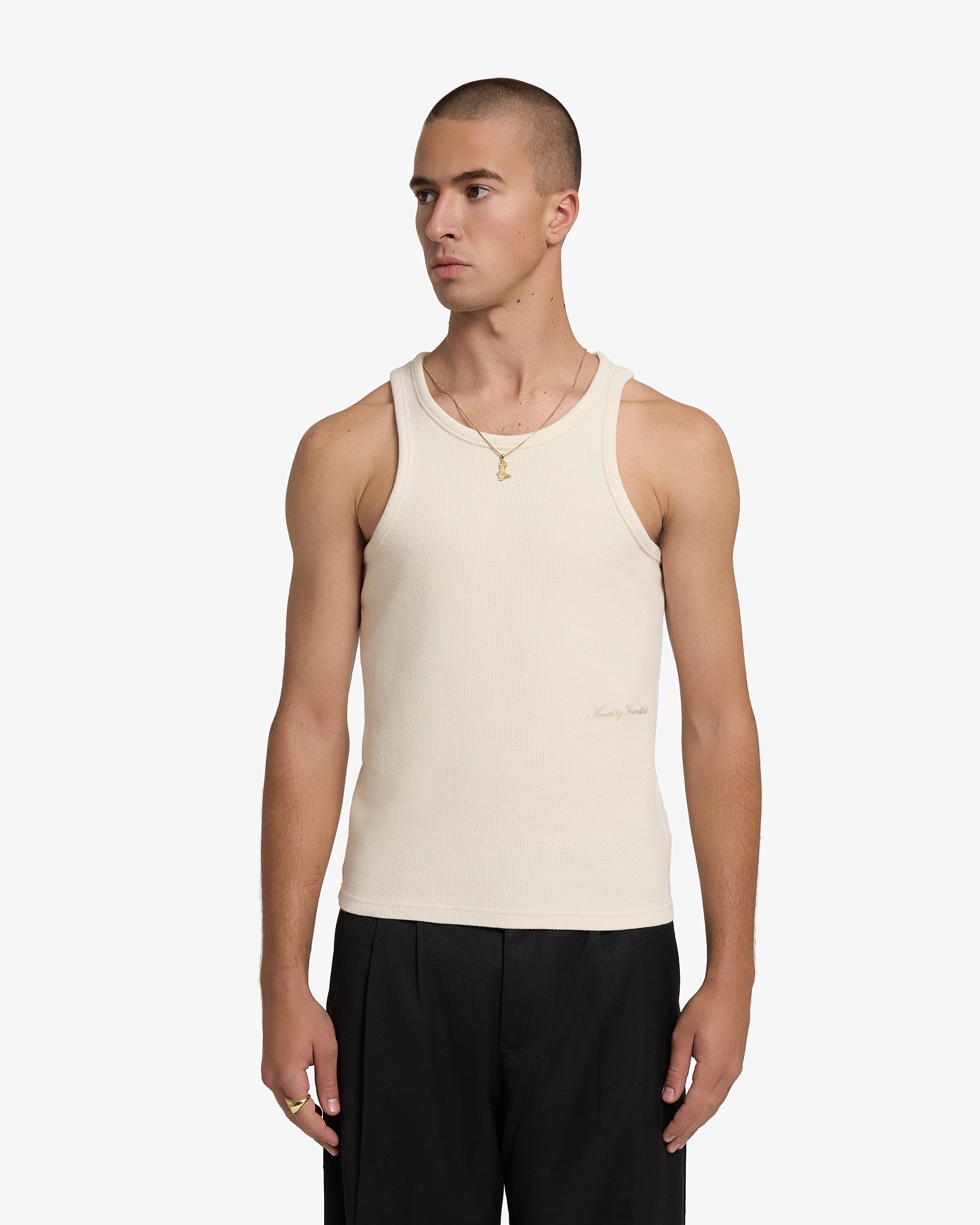 Sleeveless tank top designed with a close and elongated silhouette
Textured cotton waffle fabric with a soft and breathable feel
Slim fit with wide shoulder straps and a high-cut neckline
Tonal “Moved By Friendship” embroidery placed at the lower front
Beige base with minimal tonal detailing
Machine wash cold. Do not tumble dry
Made in Portugal