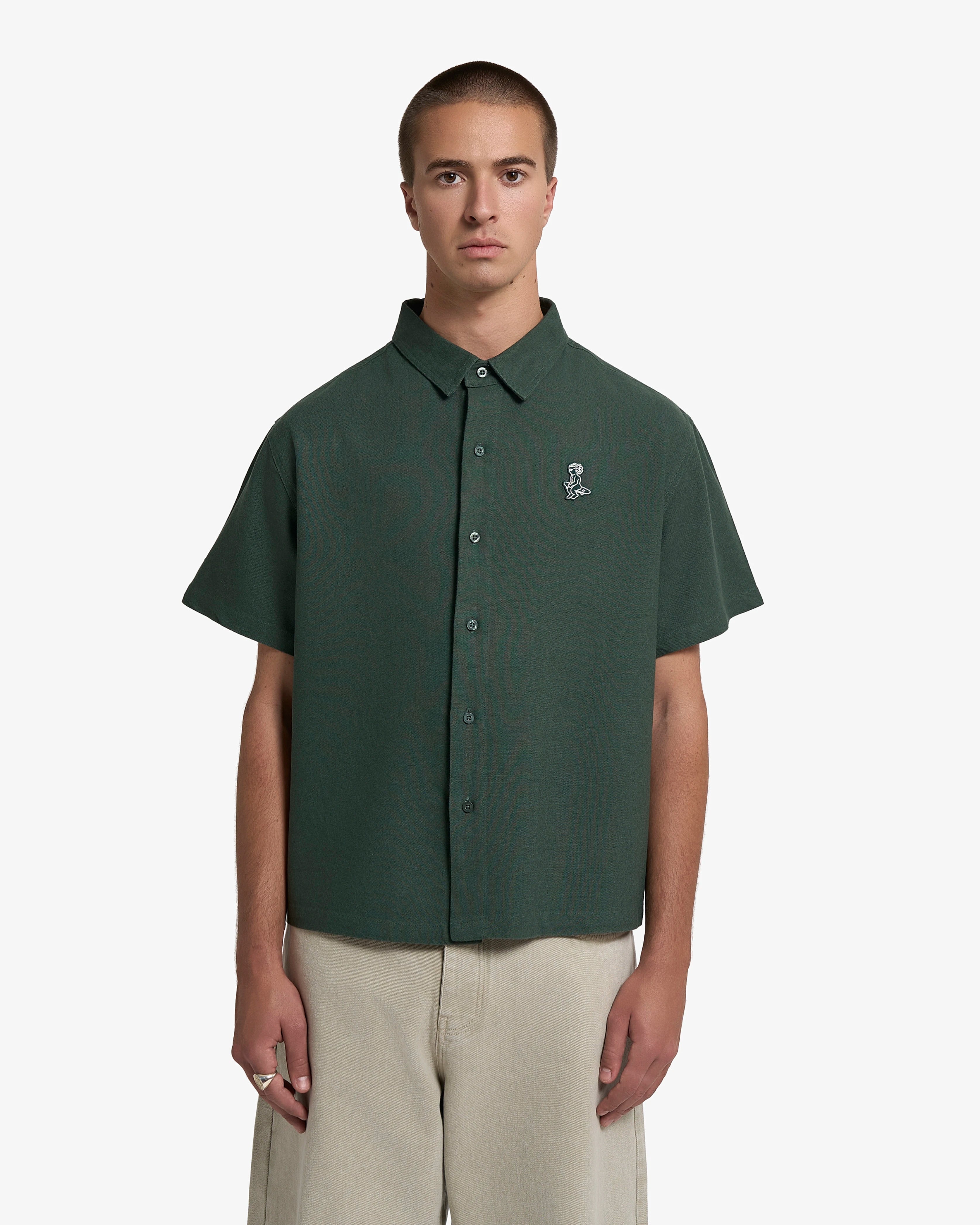 Short sleeve button-up shirt with a clean, structured appearance
100% cotton fabric with a textured weave and dry hand feel
Relaxed fit with a straight cut for ease of movement
Chest embroidered patch featuring the Ikon logo
Deep green tone with a matte finish and tonal buttons